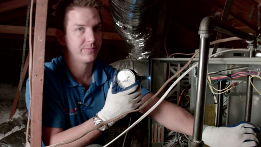 technician checking gas pressure on furnace