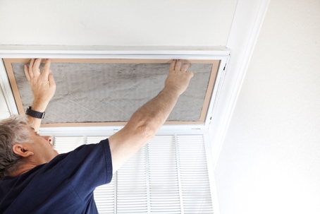 man changing dirty hvac filter