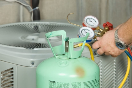 technician checking refrigerant levels